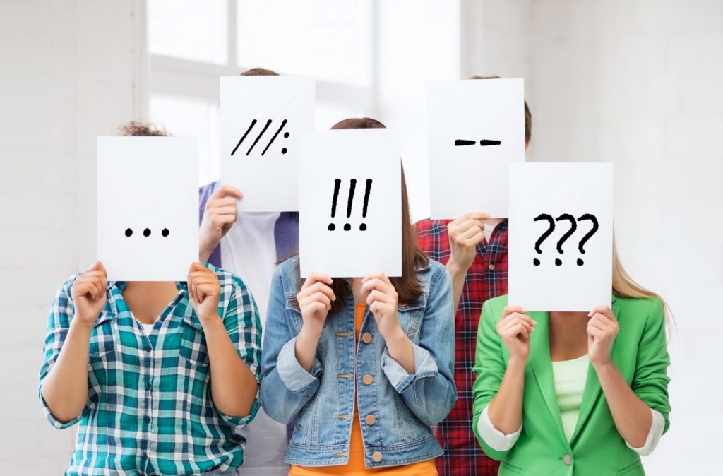 Kids with signs over their faces