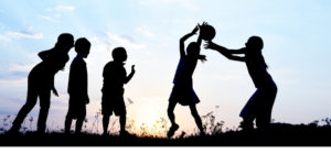 shadows of children playing ball at sunset